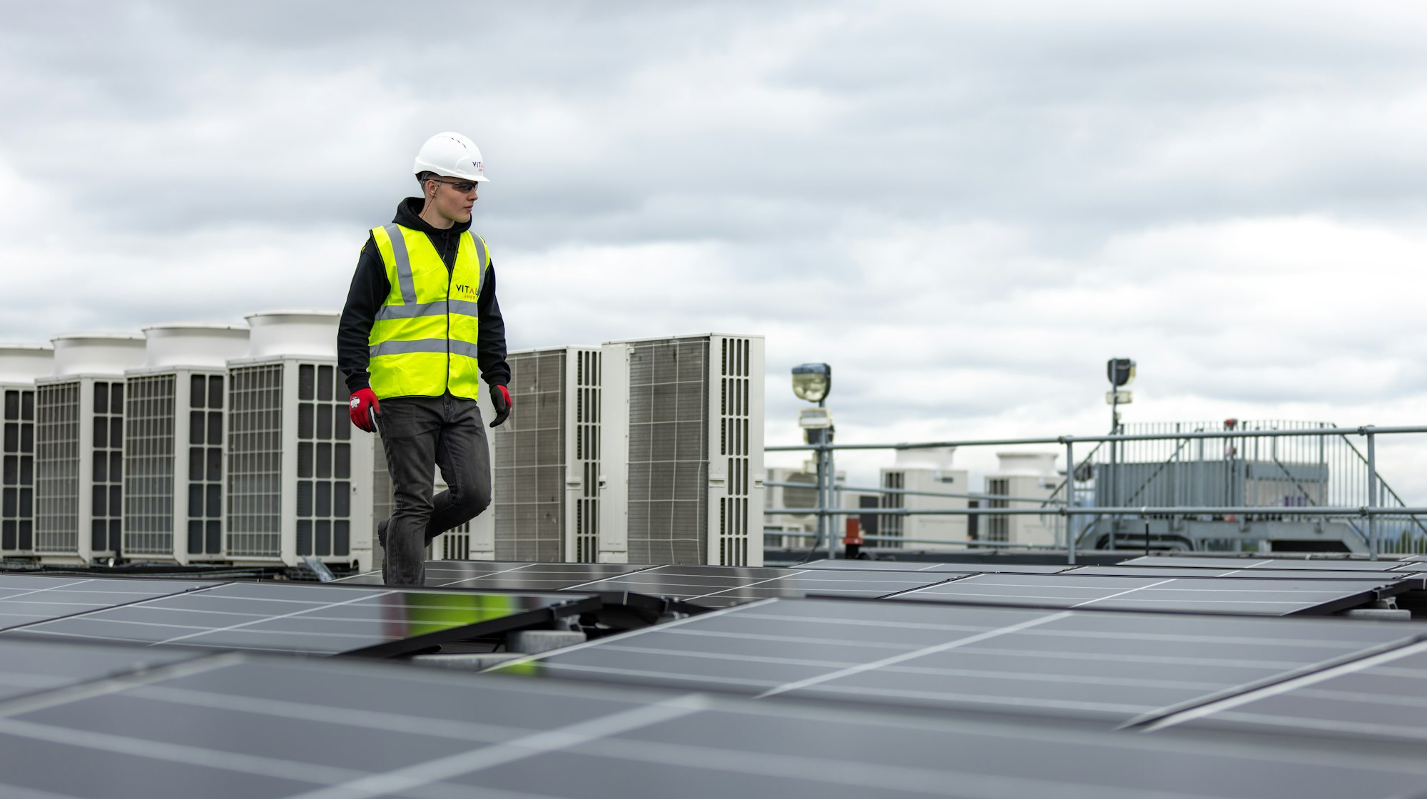 An Ironside technician on a commercial rooftop among HVAC units